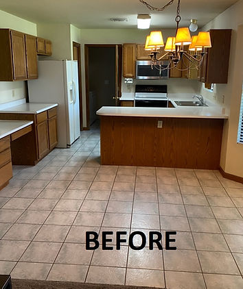 Kitchen with brown cabinets, white appliances, and tiled floor. A "before" text is centered in the image.